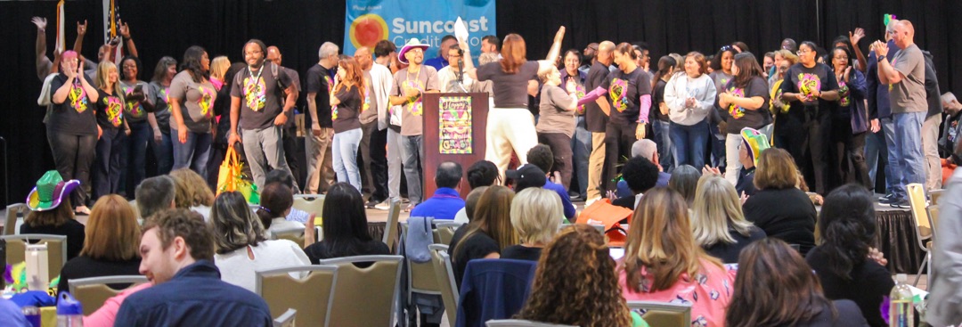 Many people on stage at Trinkle Center