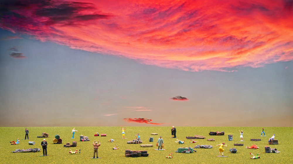 Several figures on a wide green field with foreboding red clouds above