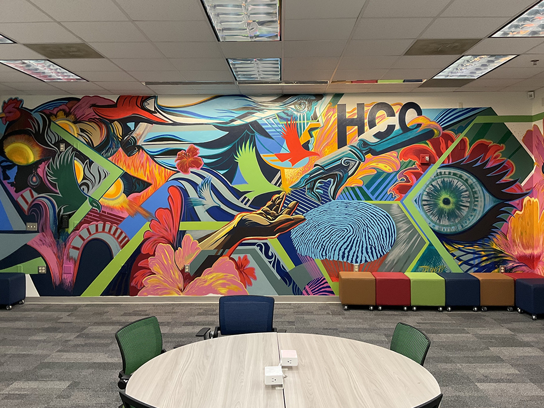 Colorful mural with abstract shapes, a large eye, a hand reaching towards a fingerprint pattern, and geometric patterns.