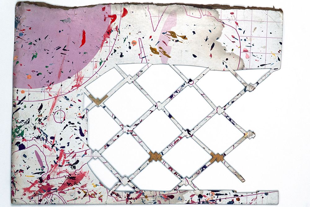 Abstract image of a torn paper with lattice cutouts and colorful paint splatters.
