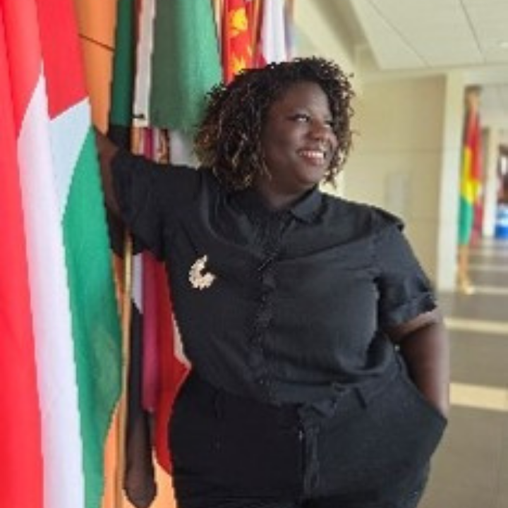 a professional shot of Dale Mabrey campus's President standing in front of a national flag.