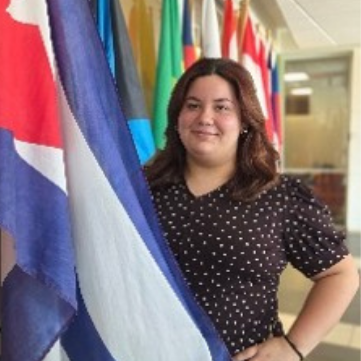a professional shot of Dale Mabrey campus's Treasurer standing in front of a national flag.