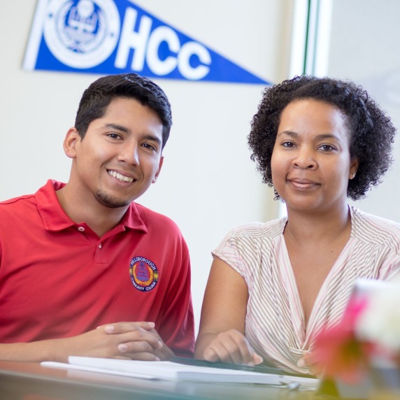 male and female students smiling at the camera