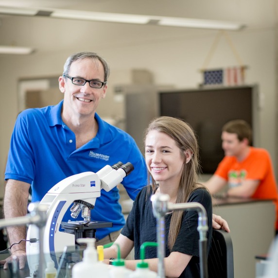 instructor and student in a science lab classroom
