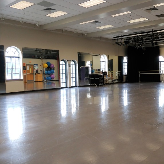 Open dance space with screen for watching videos