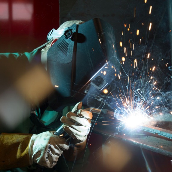 close up of student welding in protective gear