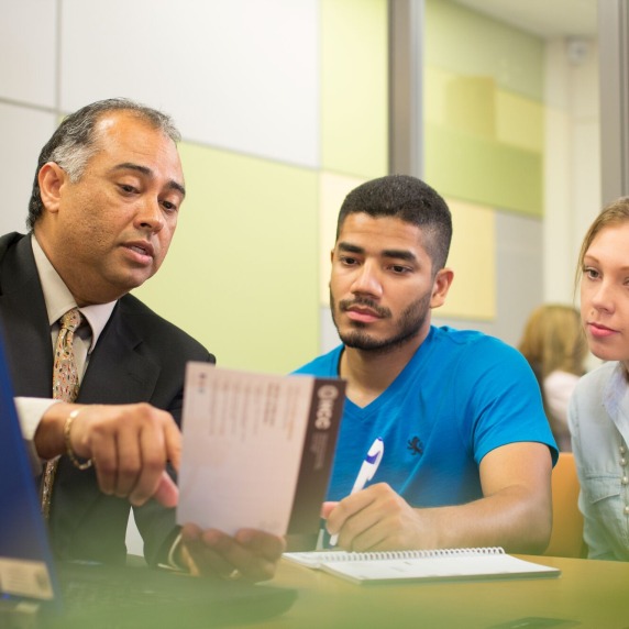 Students working with staff member. 