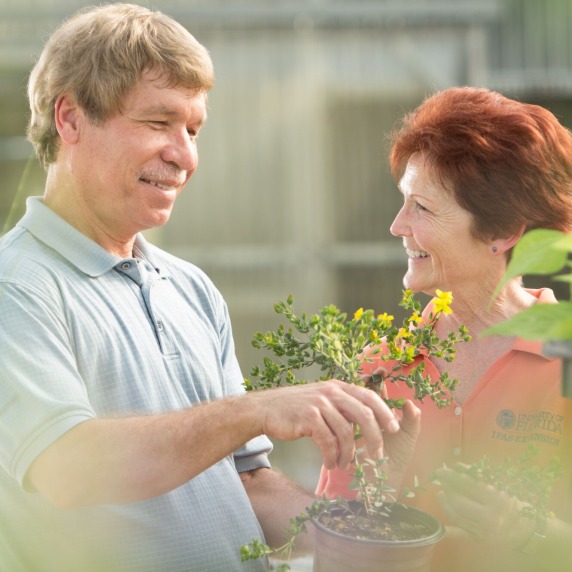 Two instructors working in garden at Plant City Campus