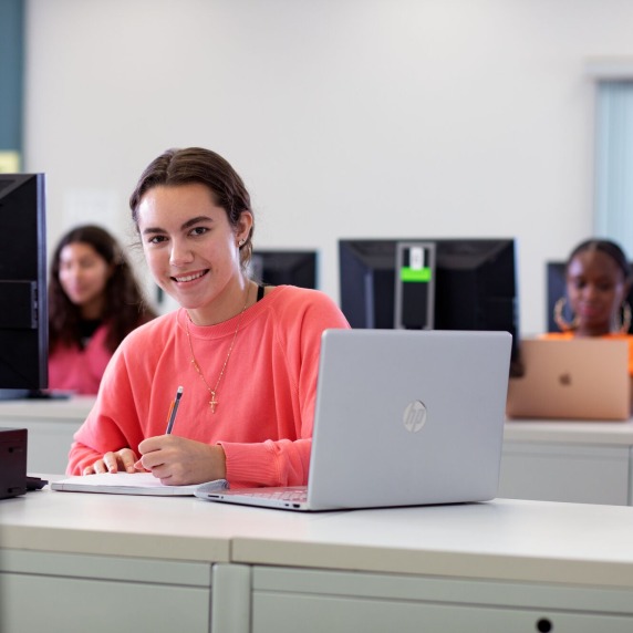 Student with laptop at desk