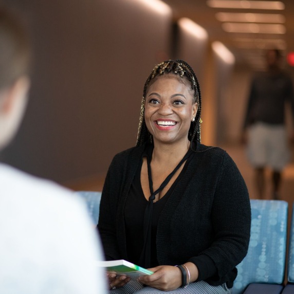 Student sitting and smiling.