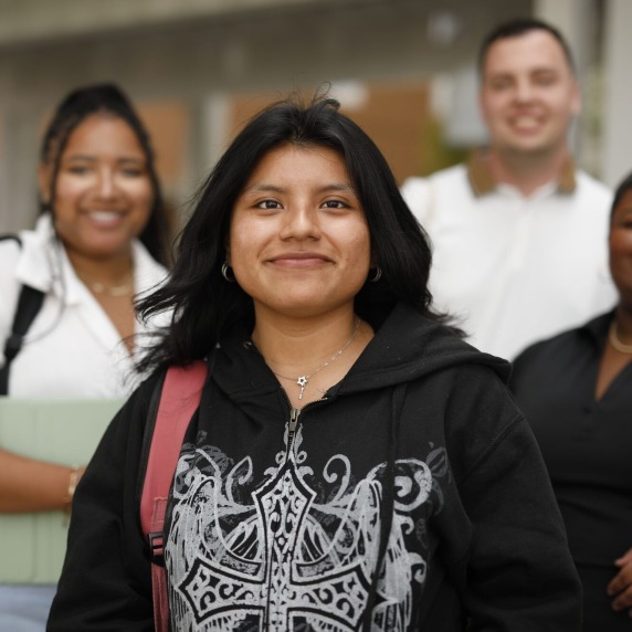 A group of four students smiling for a photo