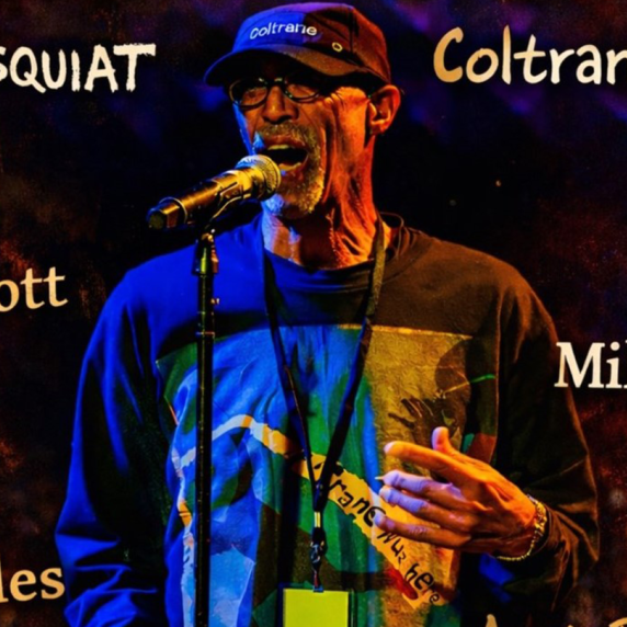 A man singing into a microphone with names like "Basquiat," "Gil Scott," and "Miles" around him.