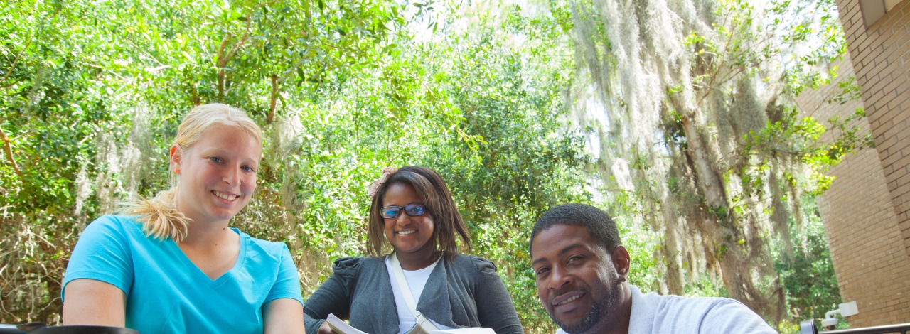 a group of students studying around a table outside