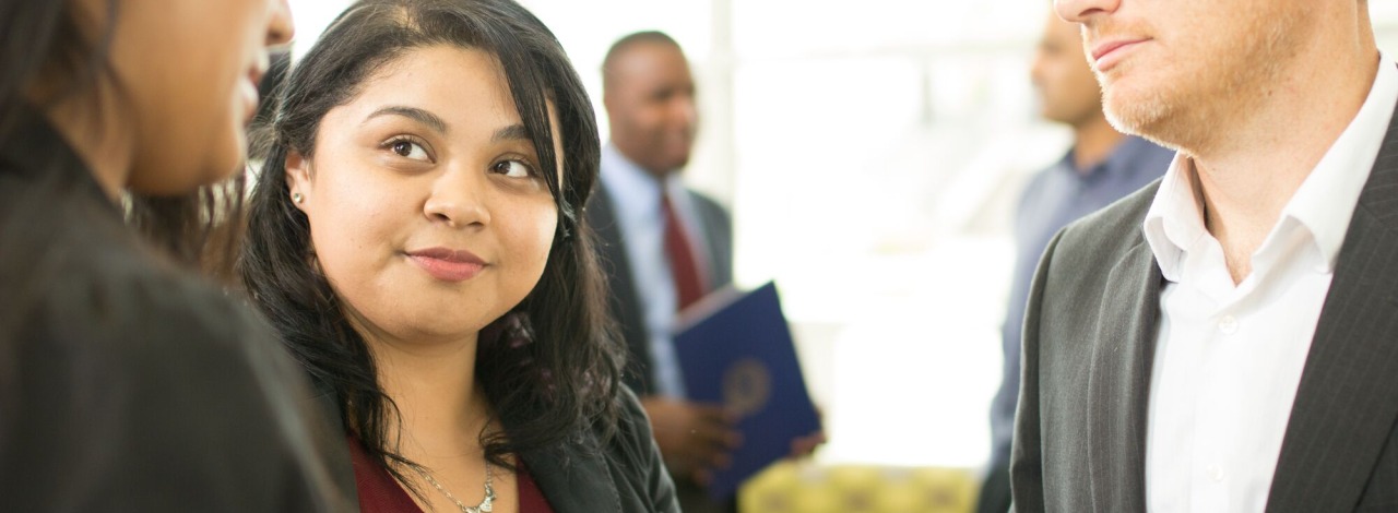 Two women and a man talking