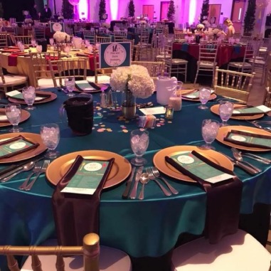 Room with purple lights and tables set for dining