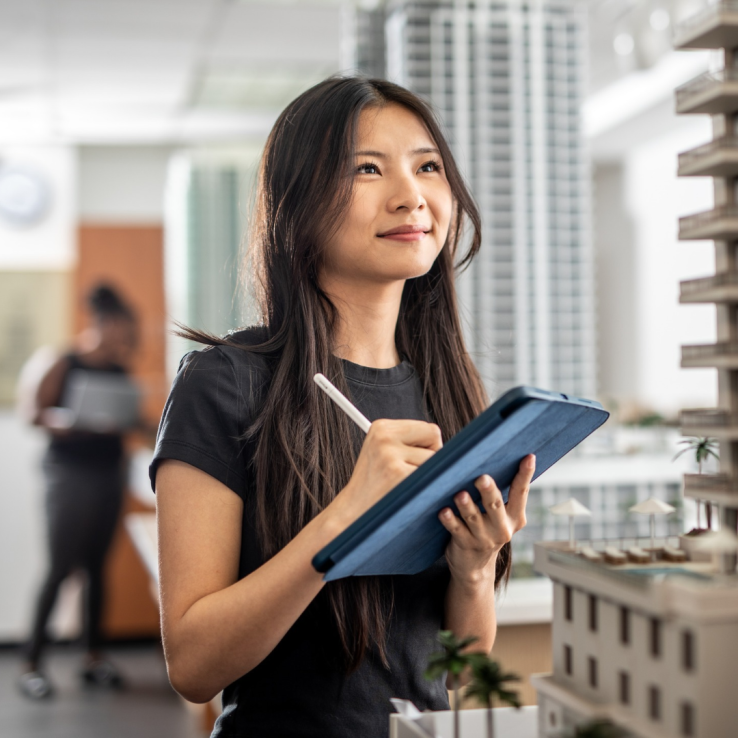 Female student taking notes on a digital tablet. 